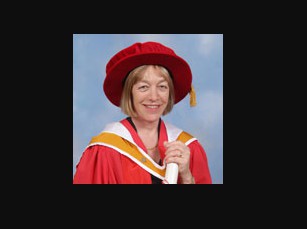 Jackie Ashley holding her graduation degree. career, professional life